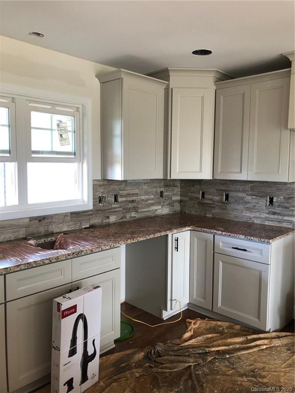 1311 George Brown Road Crouse, NC 28033 - Photo 7 of 32 a kitchen with stainless steel appliances granite countertop a stove a sink and a microwave