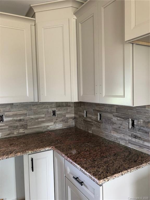 1311 George Brown Road Crouse, NC 28033 - Photo 8 of 32 a kitchen with granite countertop a sink a stove and cabinets