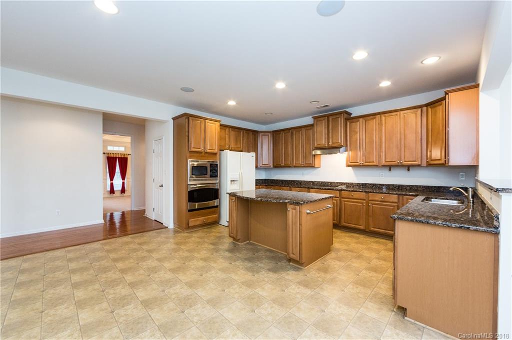 7810 Greylock Ridge Road Matthews, NC 28105 - Photo 13 of 31 a kitchen with stainless steel appliances granite countertop a refrigerator and a stove top oven