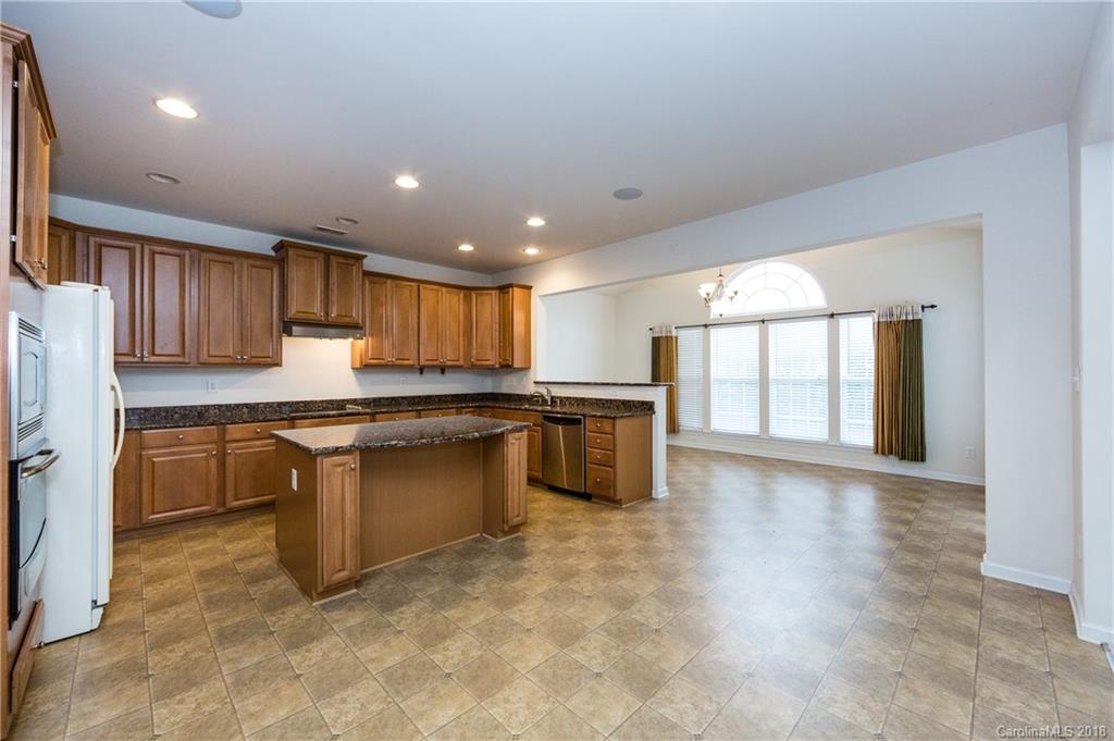 7810 Greylock Ridge Road Matthews, NC 28105 - Photo 14 of 31 a kitchen with granite countertop a sink a counter top space stainless steel appliances and cabinets