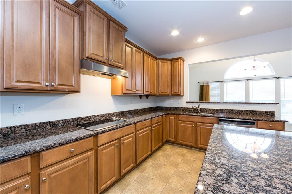 7810 Greylock Ridge Road Matthews, NC 28105 - Photo 15 of 31 a kitchen with stainless steel appliances granite countertop a sink a stove and cabinets