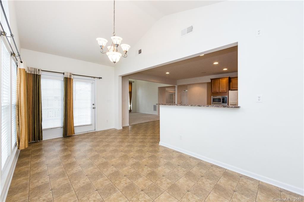 7810 Greylock Ridge Road Matthews, NC 28105 - Photo 17 of 31 a view of a big room with a chandelier fan and windows