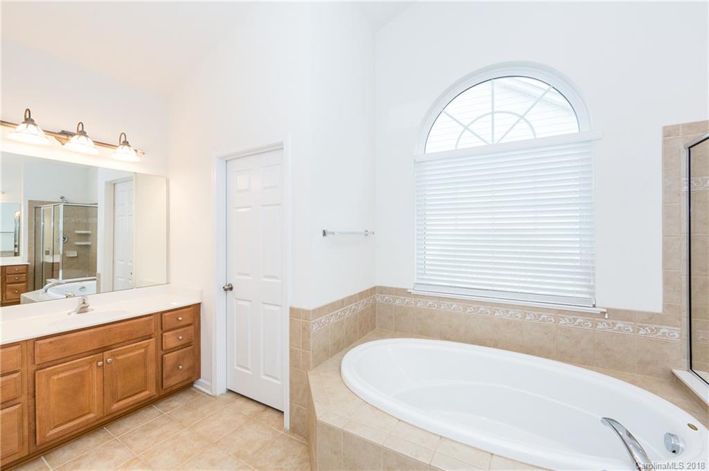 7810 Greylock Ridge Road Matthews, NC 28105 - Photo 21 of 31 a bathroom with a tub sink and mirror