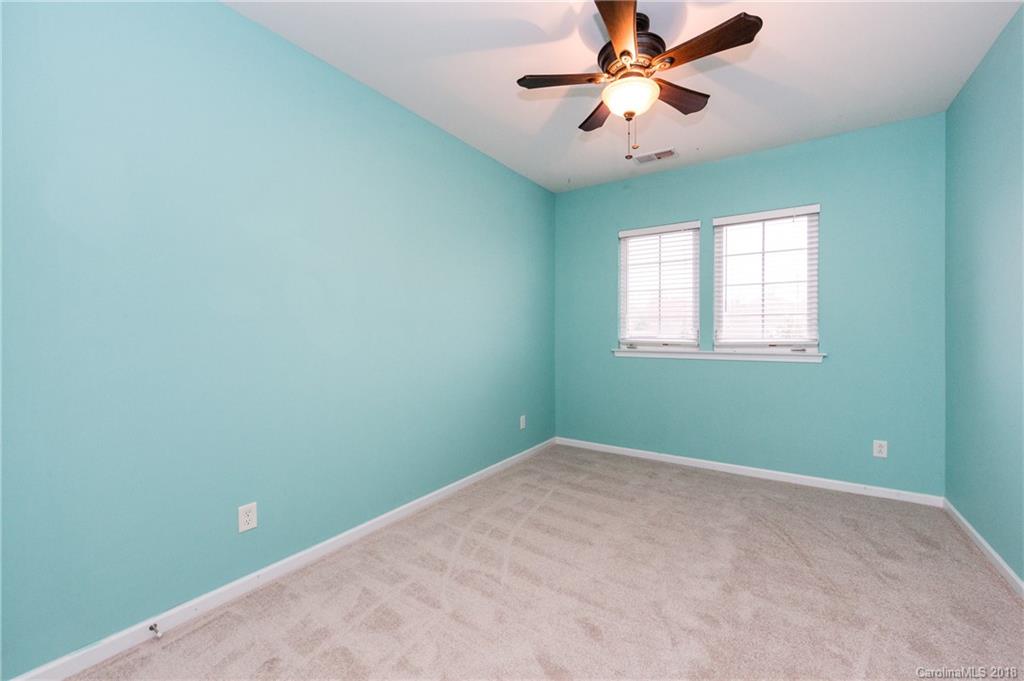 7810 Greylock Ridge Road Matthews, NC 28105 - Photo 26 of 31 an empty room with windows and fan