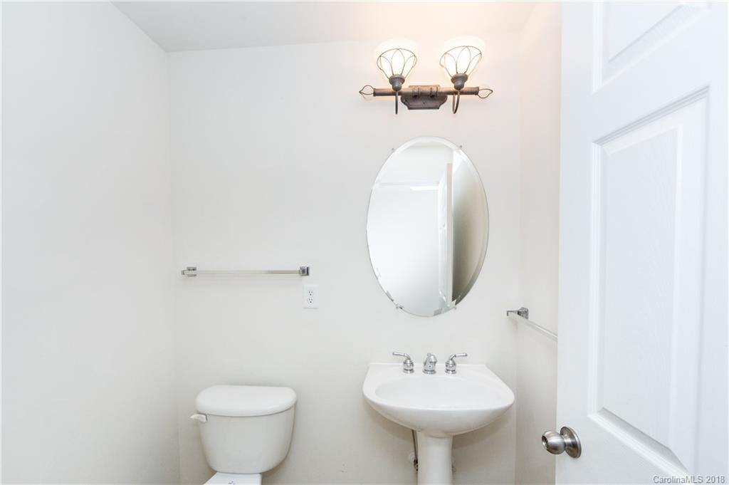 7810 Greylock Ridge Road Matthews, NC 28105 - Photo 8 of 31 a bathroom with a toilet sink and mirror