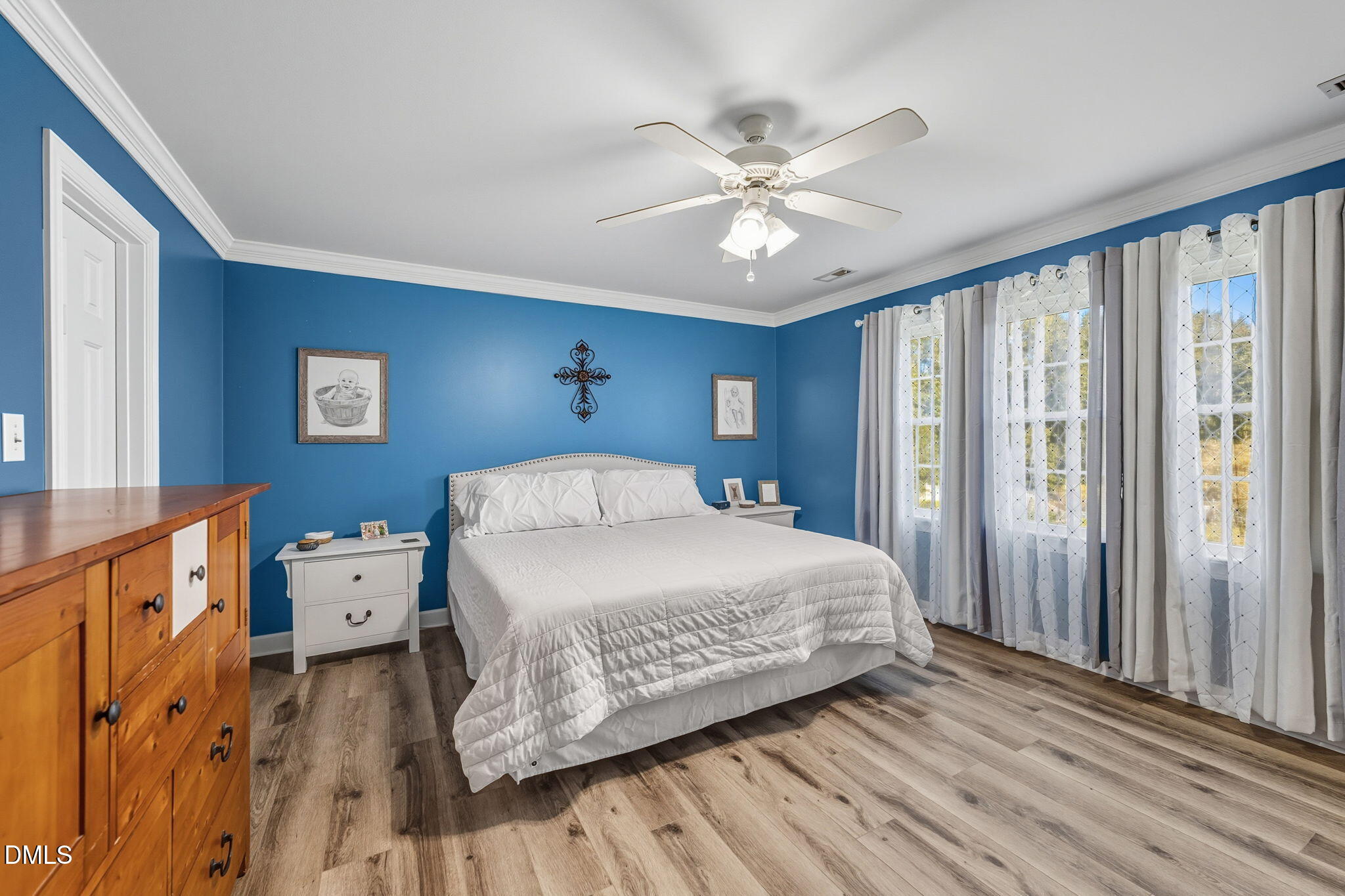 1617 Kendall Hill Road Willow Spring, NC 27592 - Photo 43 of 58 a bedroom with a bed and a chandelier
