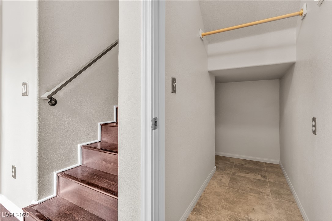 2050 West Warm Springs Road, Unit 1822 Henderson, NV 89014 - Photo 31 of 55 Under the Stairway walk in coat/storage closet with baseboards and neutral colored ceramic tile flooring.