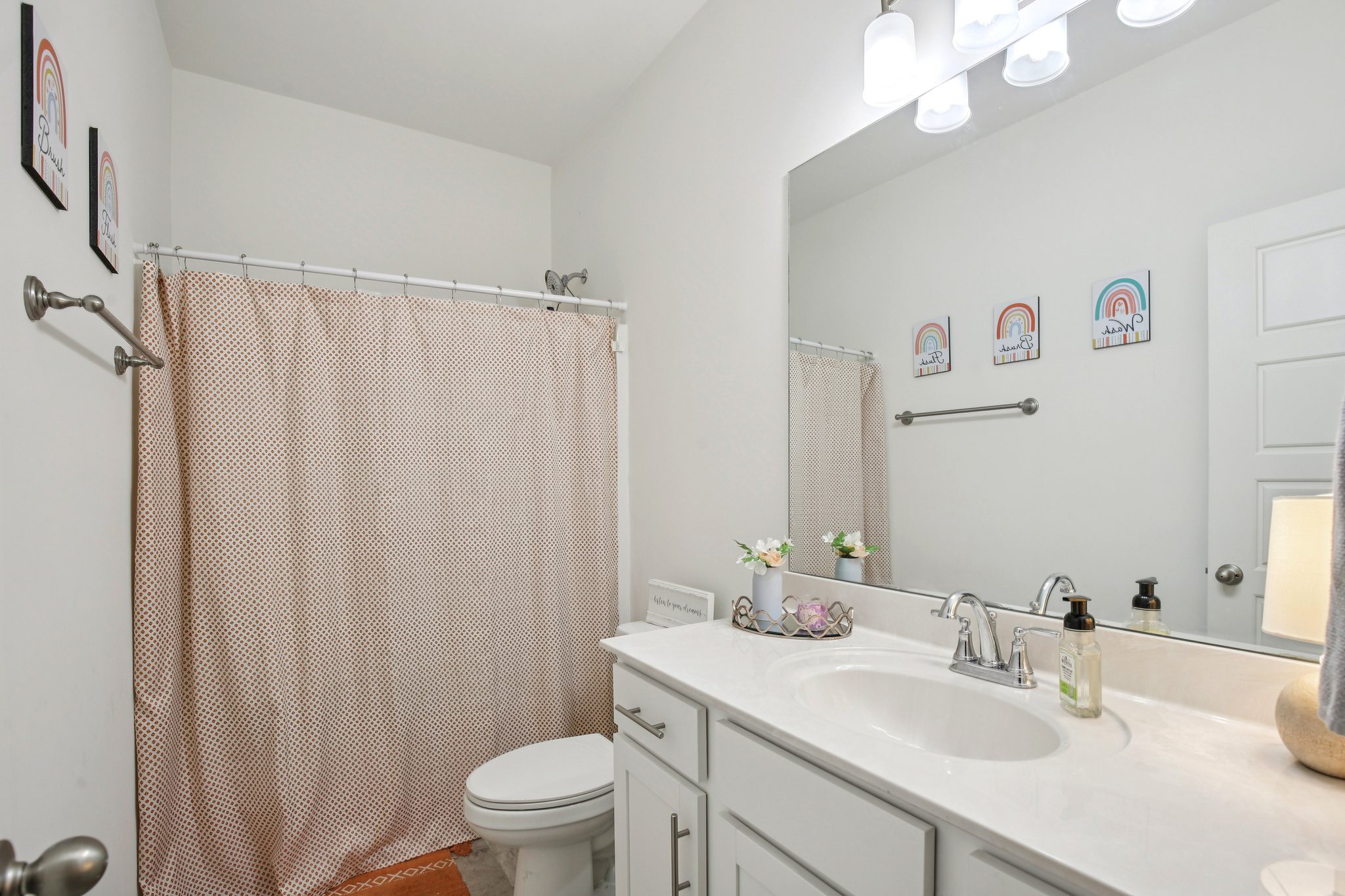 513 Baxter Crossing Lebanon, TN 37087 - Photo 56 of 74 a bathroom with a sink a toilet a mirror and shower curtain