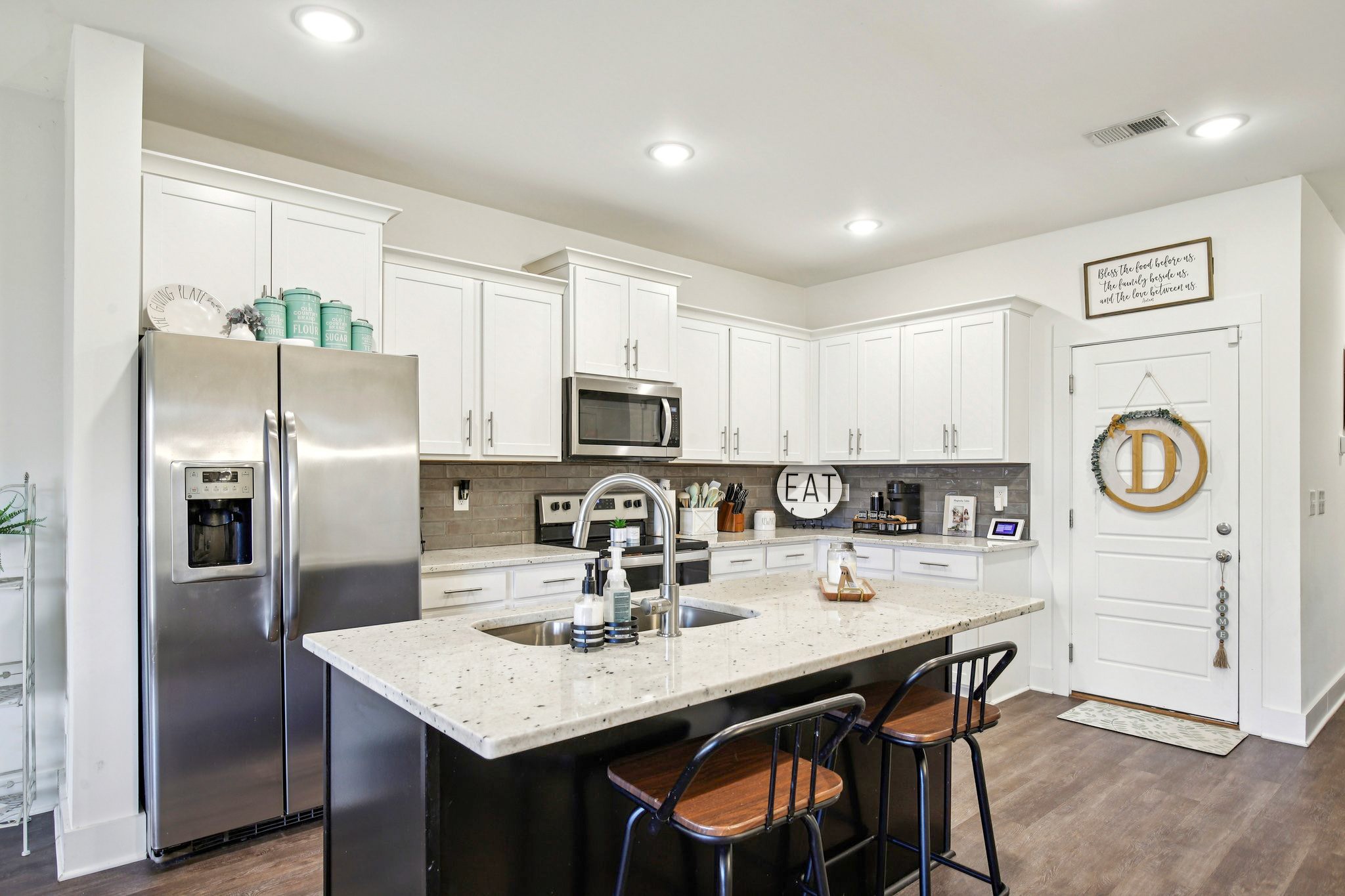 513 Baxter Crossing Lebanon, TN 37087 - Photo 10 of 74 a kitchen with stainless steel appliances granite countertop a sink a stove a refrigerator with white cabinets and wooden floor