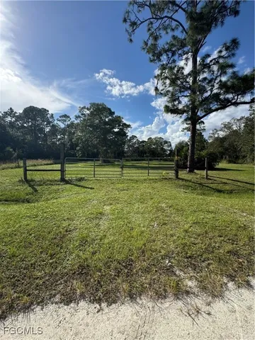 a view of outdoor space with green field and trees
