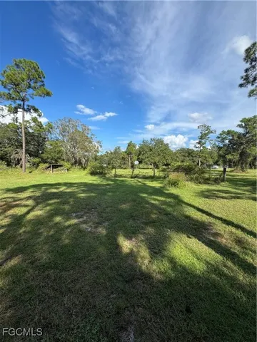 a view of a golf course with a big yard