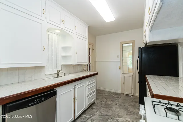 a kitchen with a sink appliances and cabinets