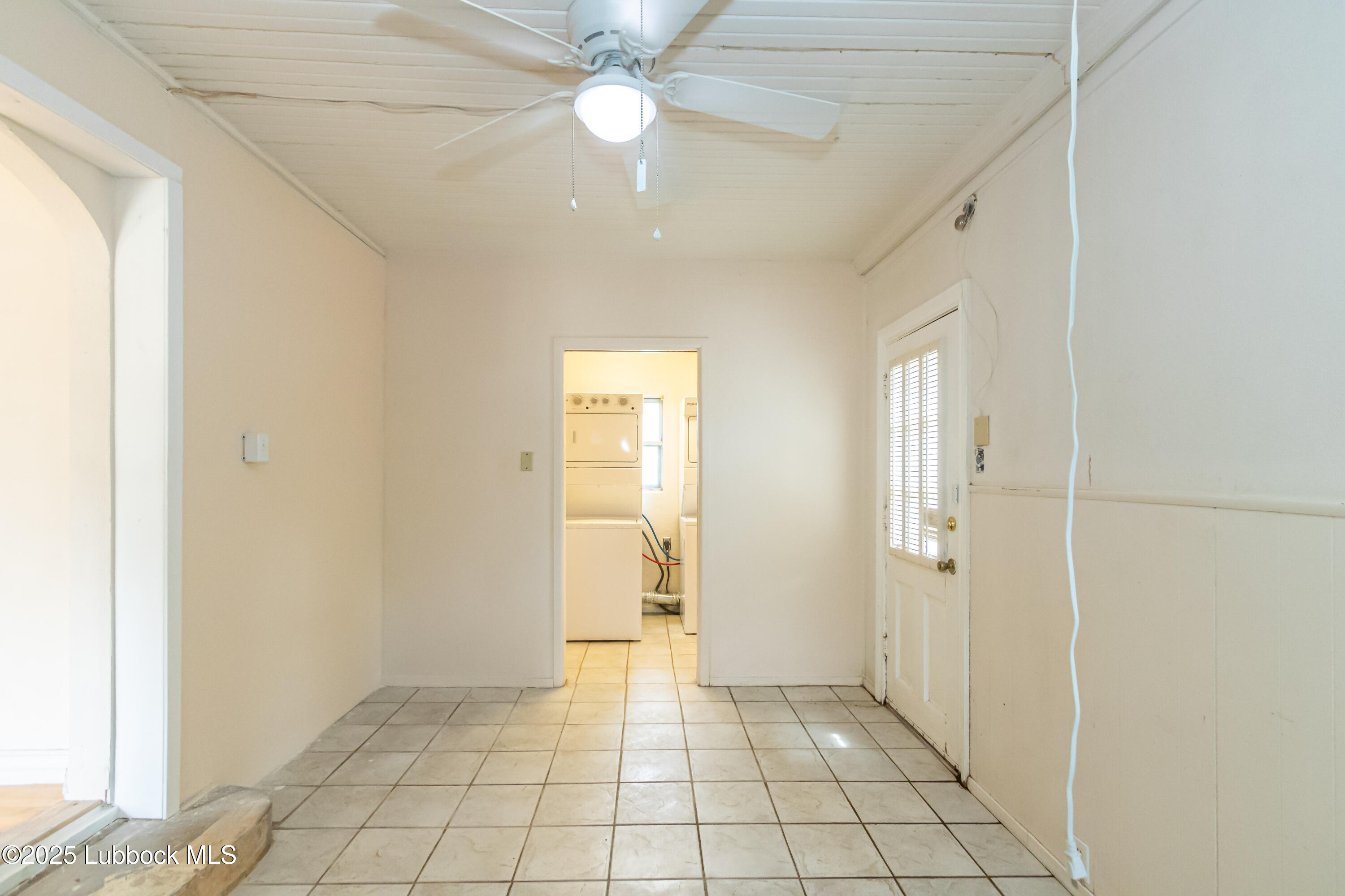 2324 17th Street Lubbock, TX 79401 - Photo 13 of 34 a view of an empty room with window and chandelier fan