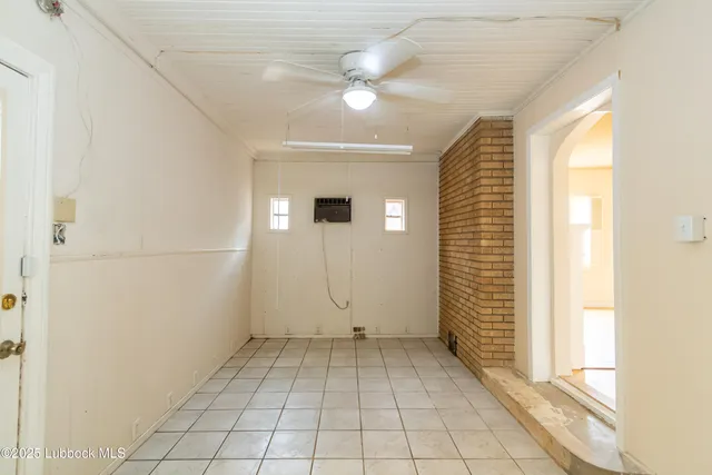 a view of empty room with wooden floor and window