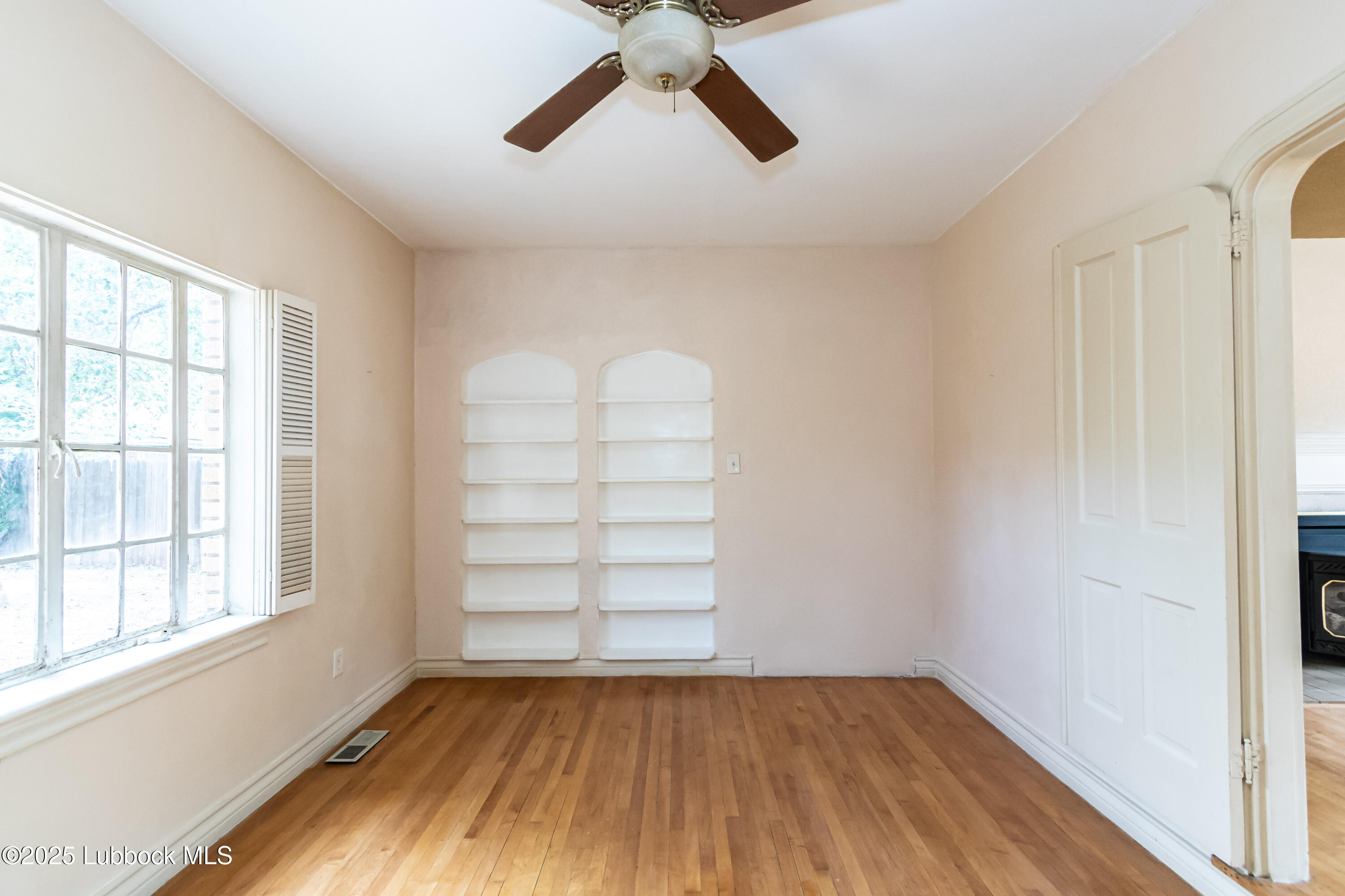 2324 17th Street Lubbock, TX 79401 - Photo 15 of 34 a view of empty room with wooden floor and window