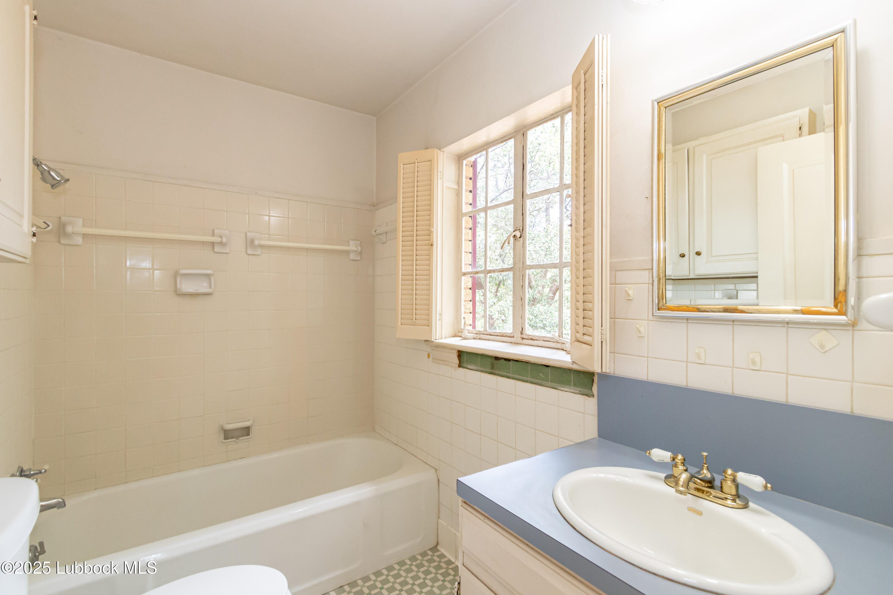 2324 17th Street Lubbock, TX 79401 - Photo 24 of 34 a bathroom with a sink toilet and bathtub