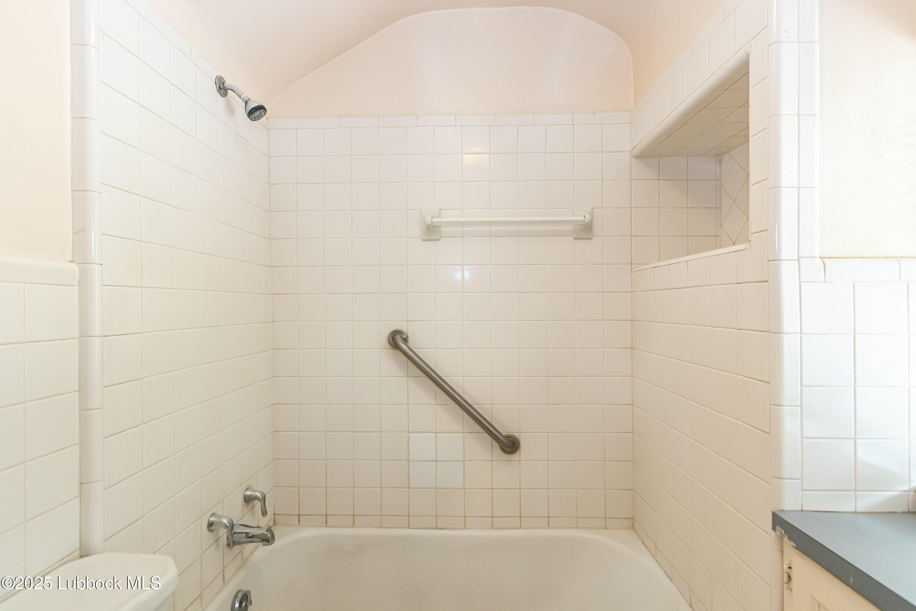 2324 17th Street Lubbock, TX 79401 - Photo 27 of 34 a bathroom with a shower and a bathtub