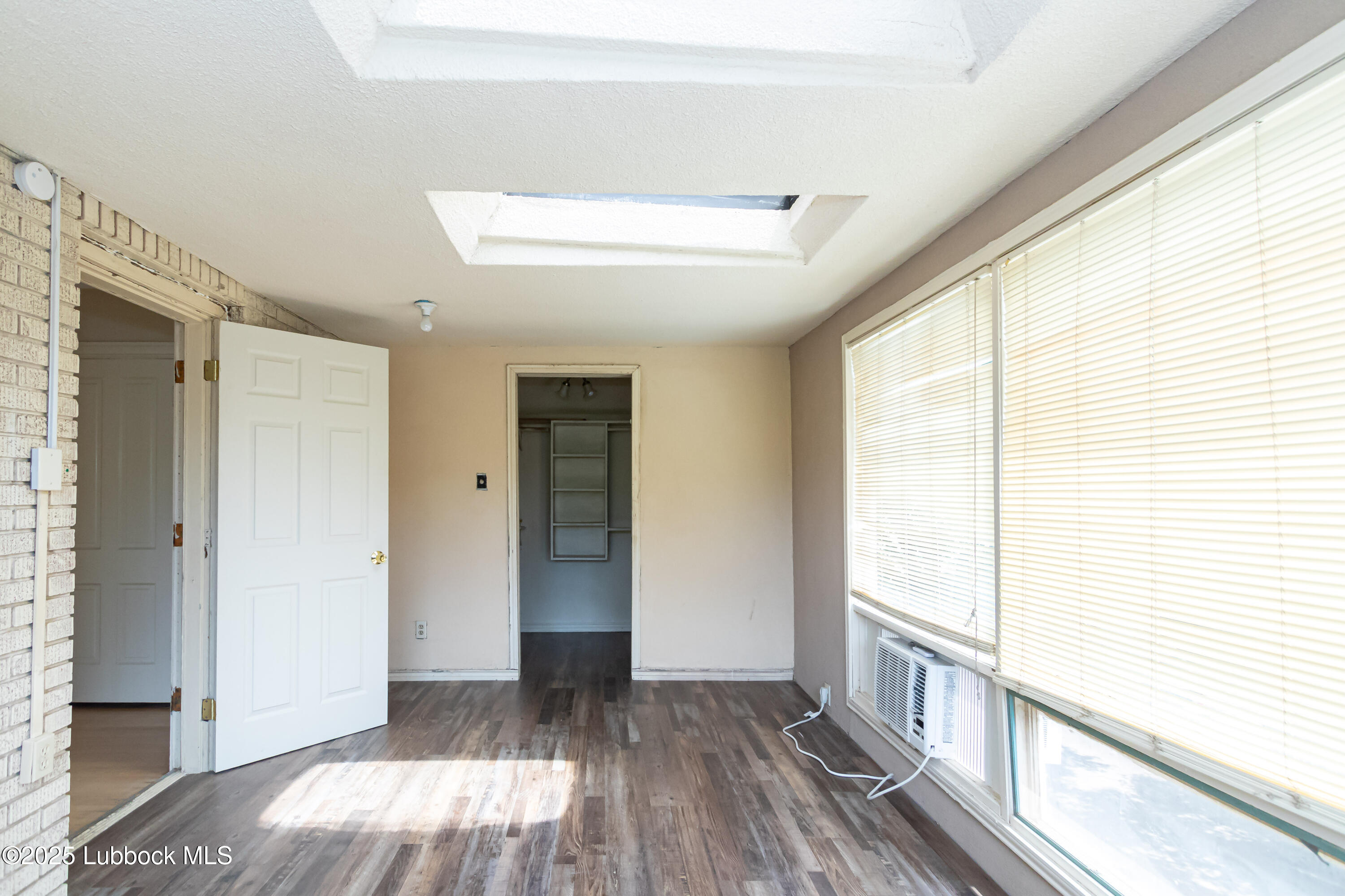 2324 17th Street Lubbock, TX 79401 - Photo 30 of 34 a view of a room with wooden floor and doors