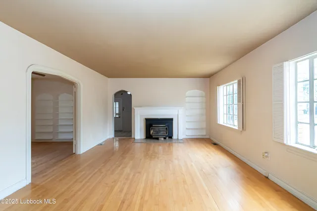 a view of a livingroom with a fireplace and window