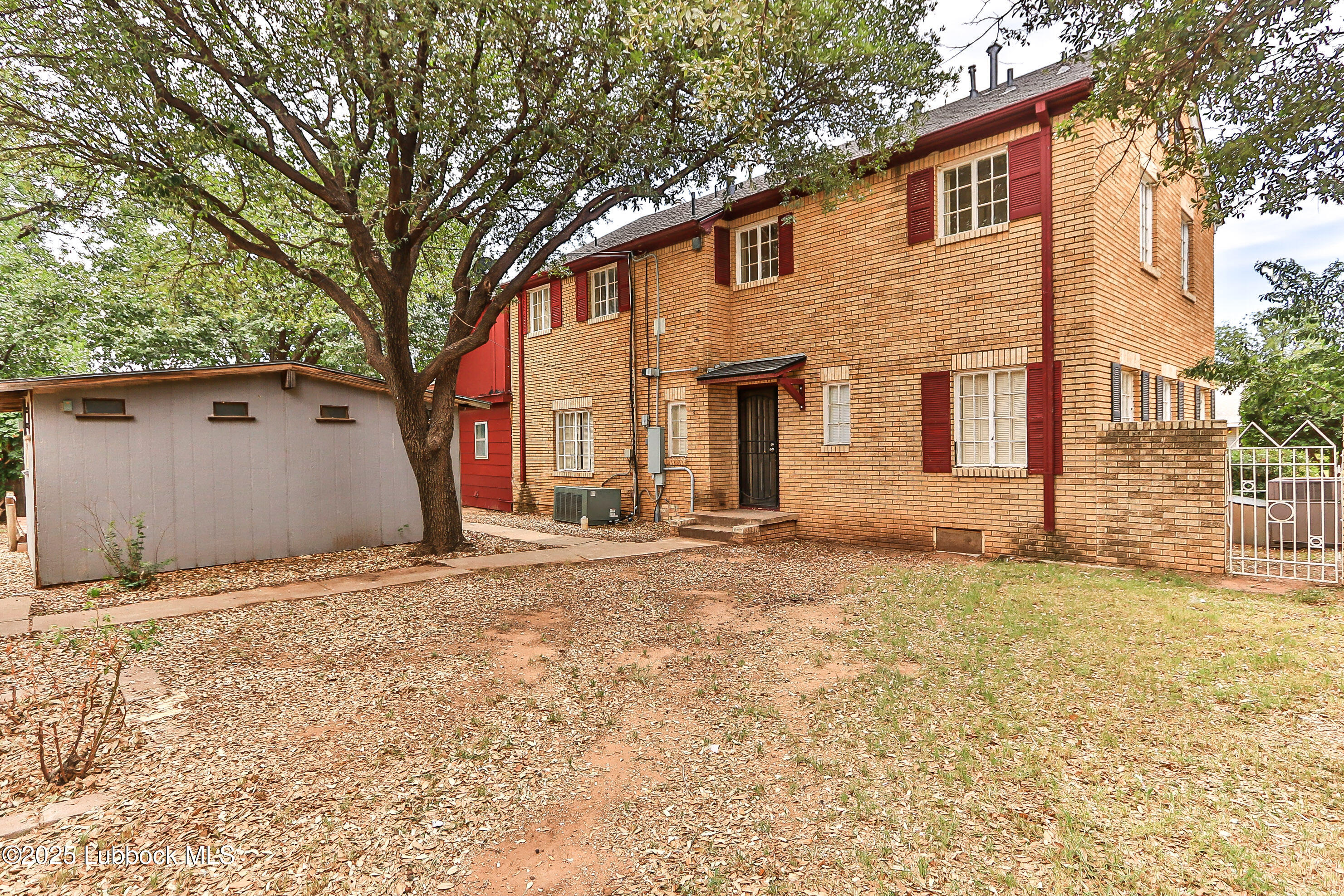 2324 17th Street Lubbock, TX 79401 - Photo 32 of 34 a front view of a house with a yard and garage