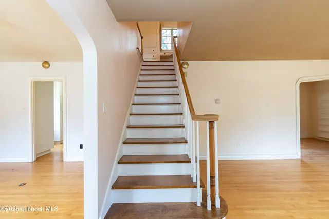 a view of entryway and hall with wooden floor