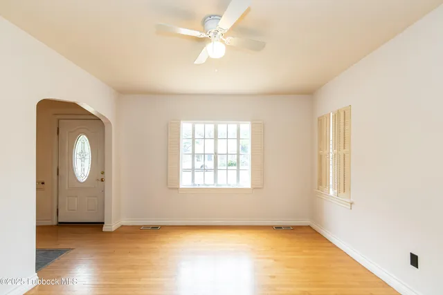 an empty room with windows and closet