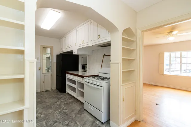 a kitchen with stainless steel appliances granite countertop a stove and a refrigerator