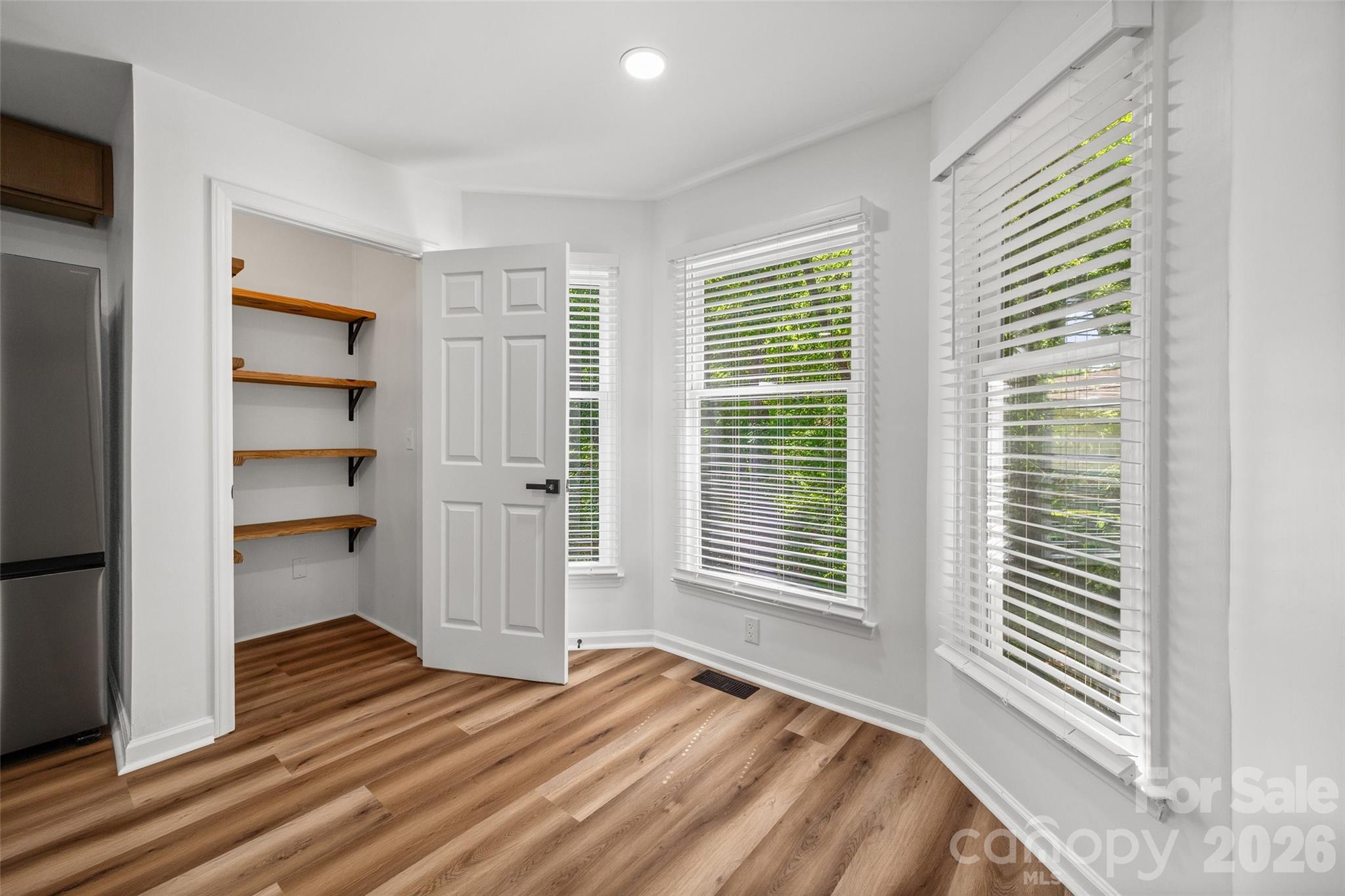 5043 Suwarrow Circle Tega Cay, SC 29708 - Photo 12 of 22 a view of a bedroom with a window and wooden floor