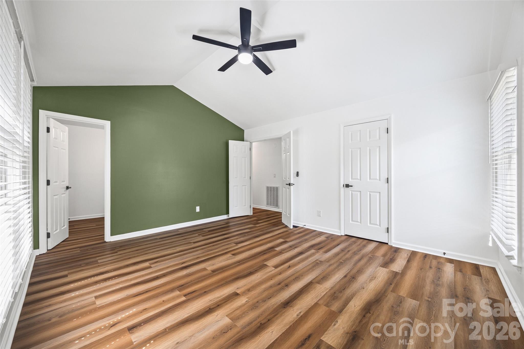 5043 Suwarrow Circle Tega Cay, SC 29708 - Photo 13 of 22 a view of a livingroom with wooden floor and a ceiling fan