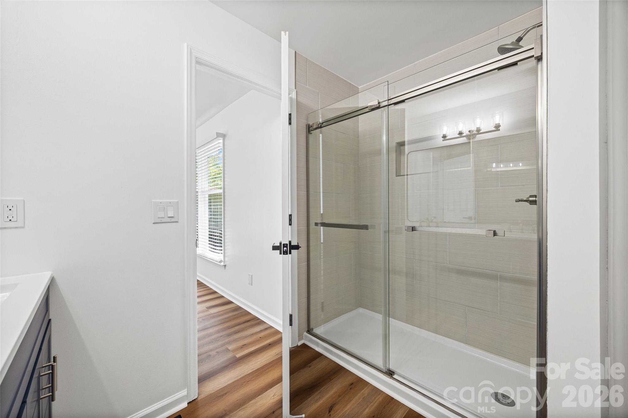 5043 Suwarrow Circle Tega Cay, SC 29708 - Photo 16 of 22 a bathroom with a glass shower door