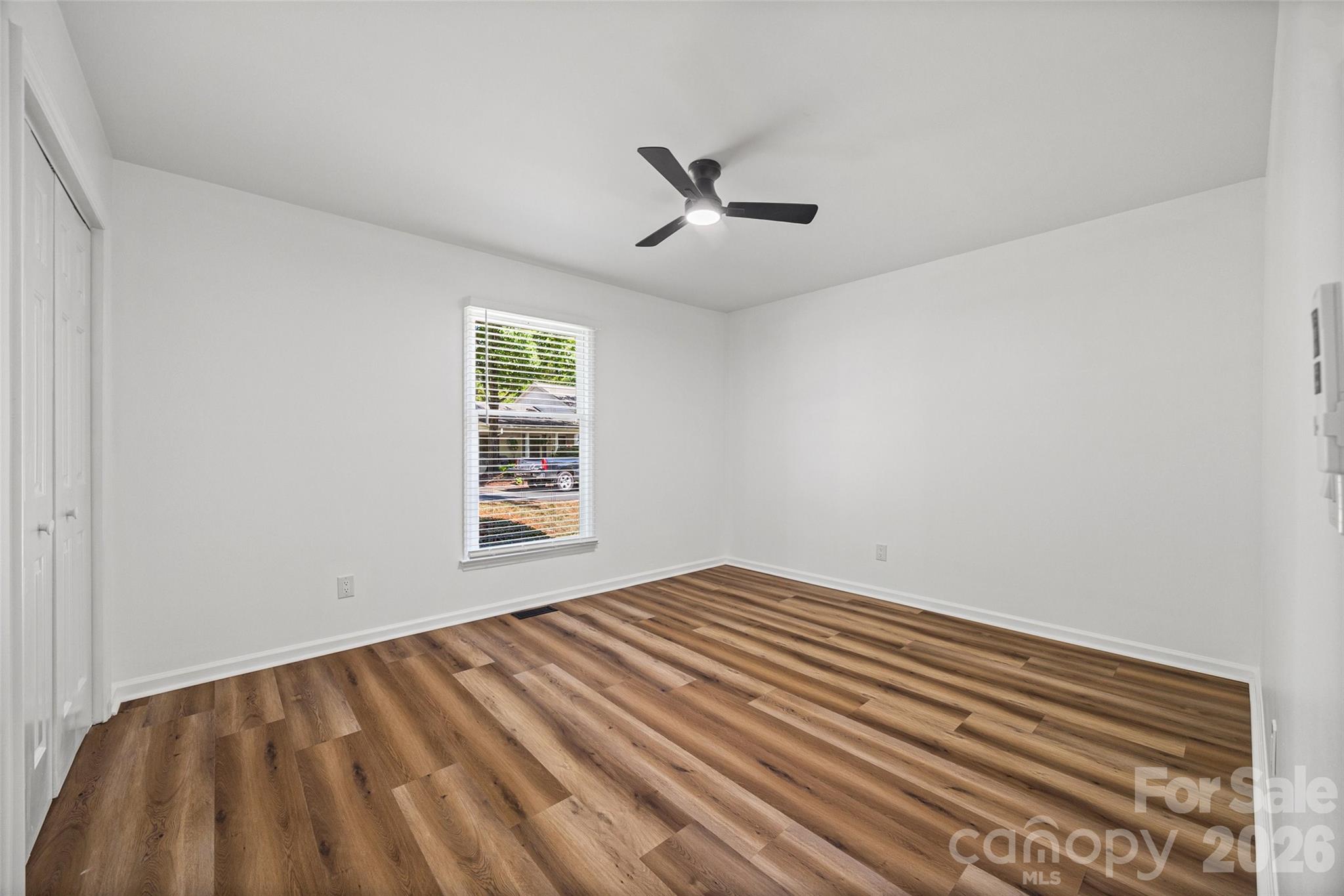 5043 Suwarrow Circle Tega Cay, SC 29708 - Photo 18 of 22 wooden floor in an empty room with a window