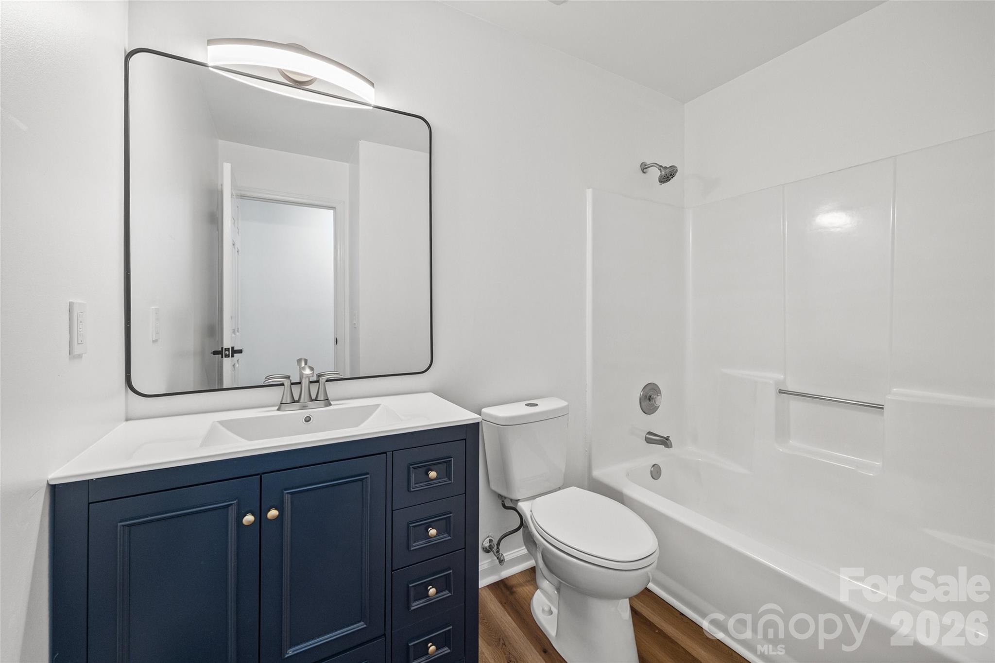 5043 Suwarrow Circle Tega Cay, SC 29708 - Photo 19 of 22 a bathroom with a granite countertop toilet sink and mirror