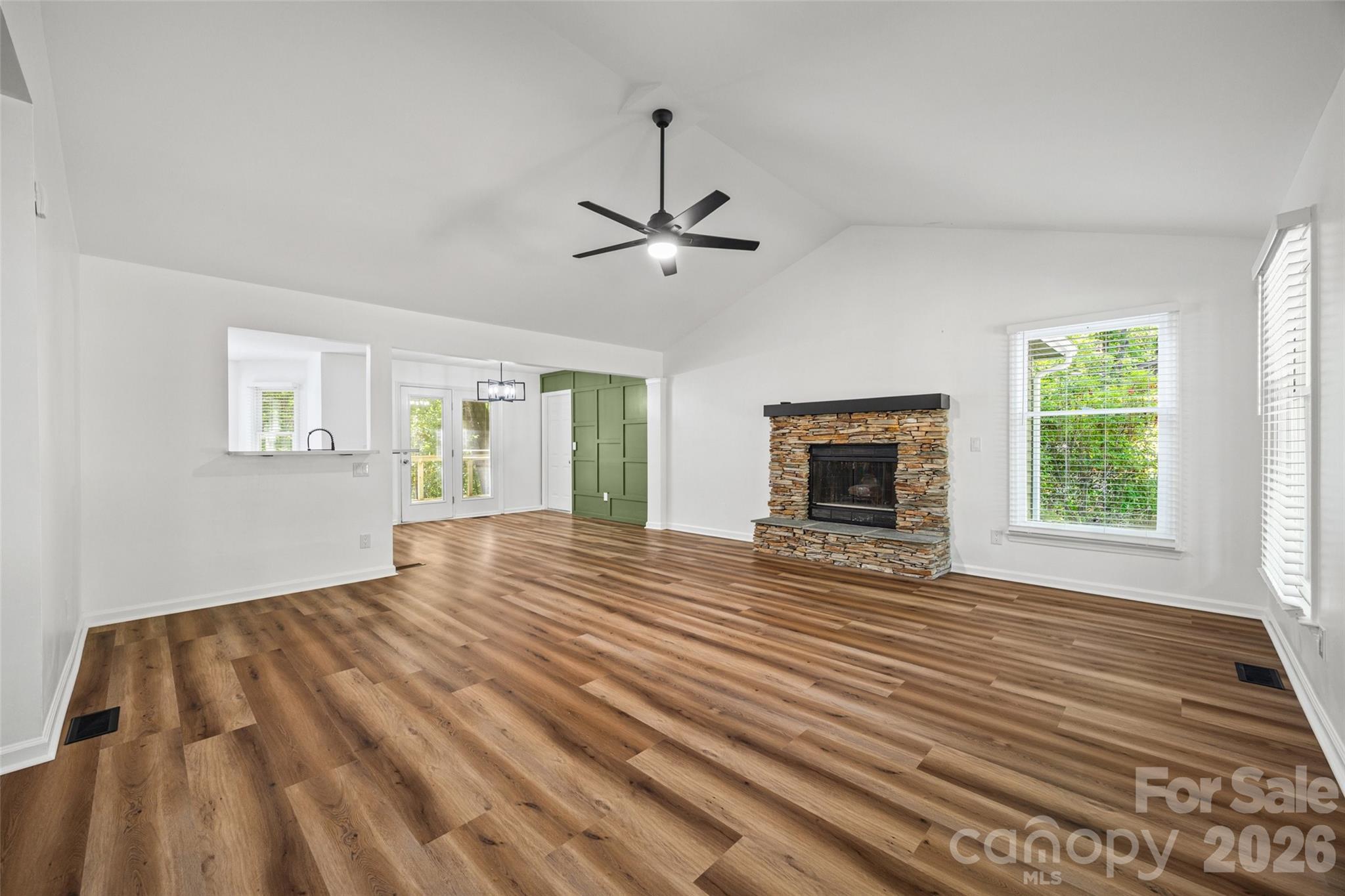 5043 Suwarrow Circle Tega Cay, SC 29708 - Photo 3 of 22 a view of an empty room with wooden floor fireplace and a window