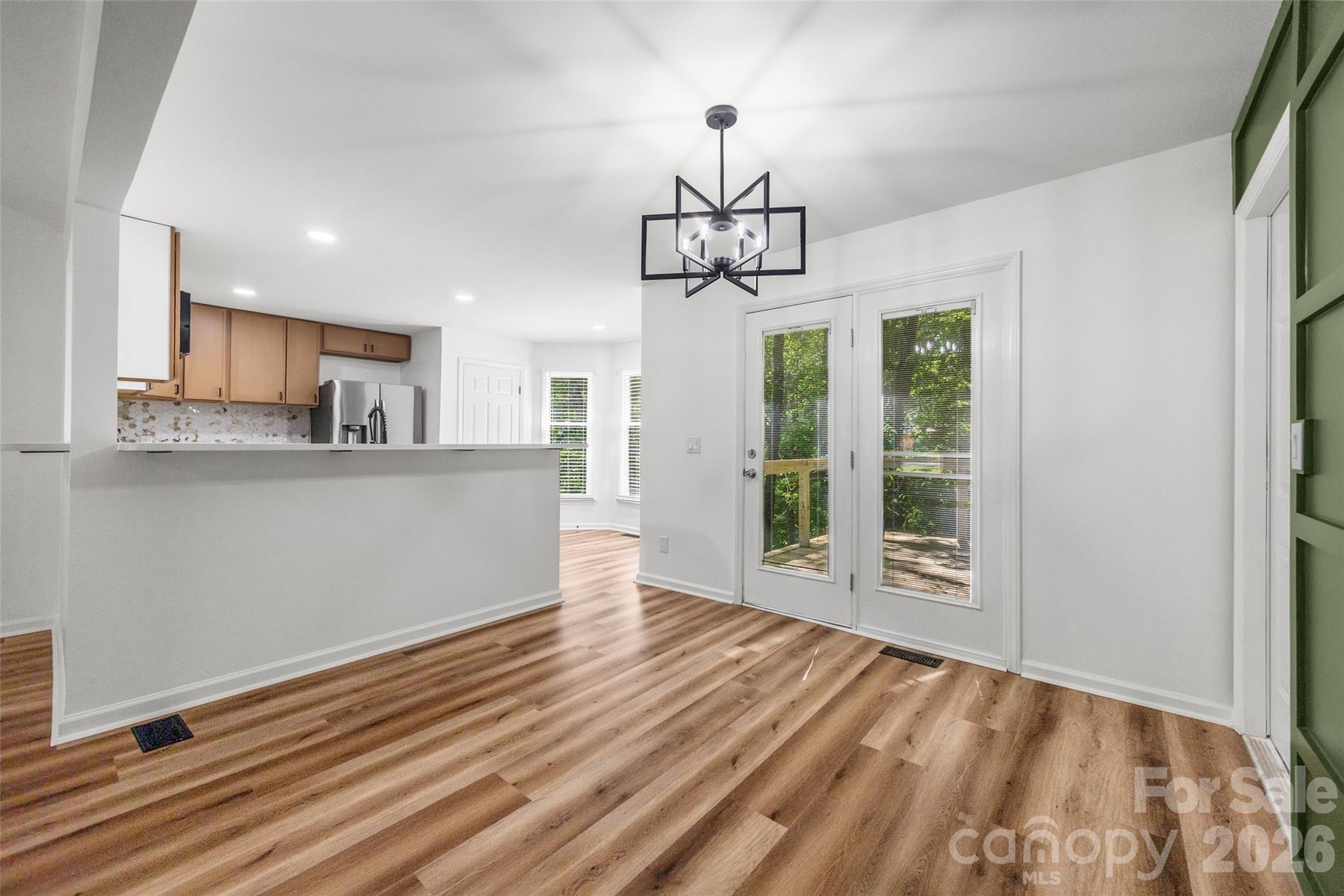 5043 Suwarrow Circle Tega Cay, SC 29708 - Photo 6 of 22 a view of a kitchen with wooden floor and windows