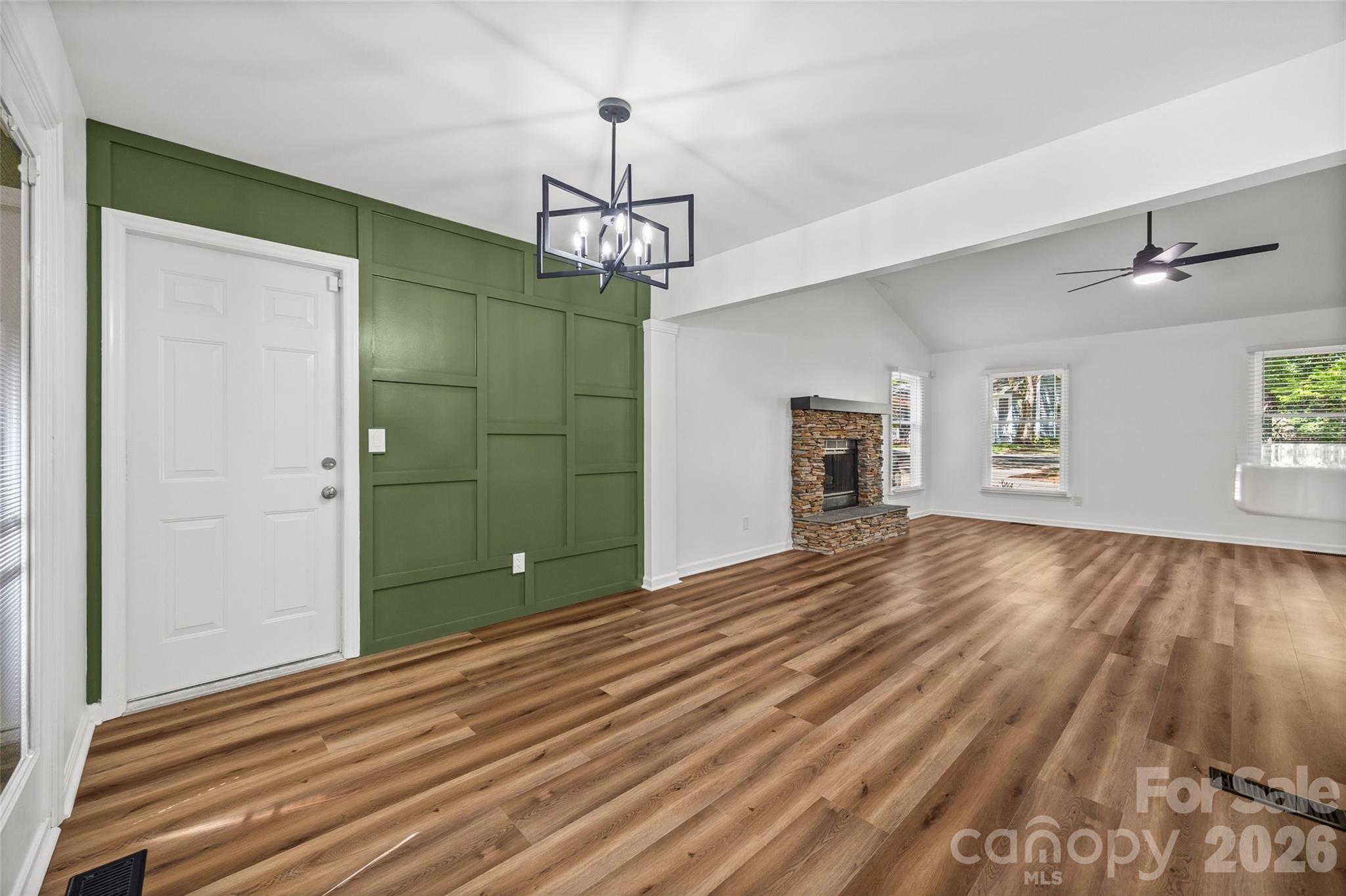 5043 Suwarrow Circle Tega Cay, SC 29708 - Photo 7 of 22 a view of a room with wooden floor staircase and a ceiling fan