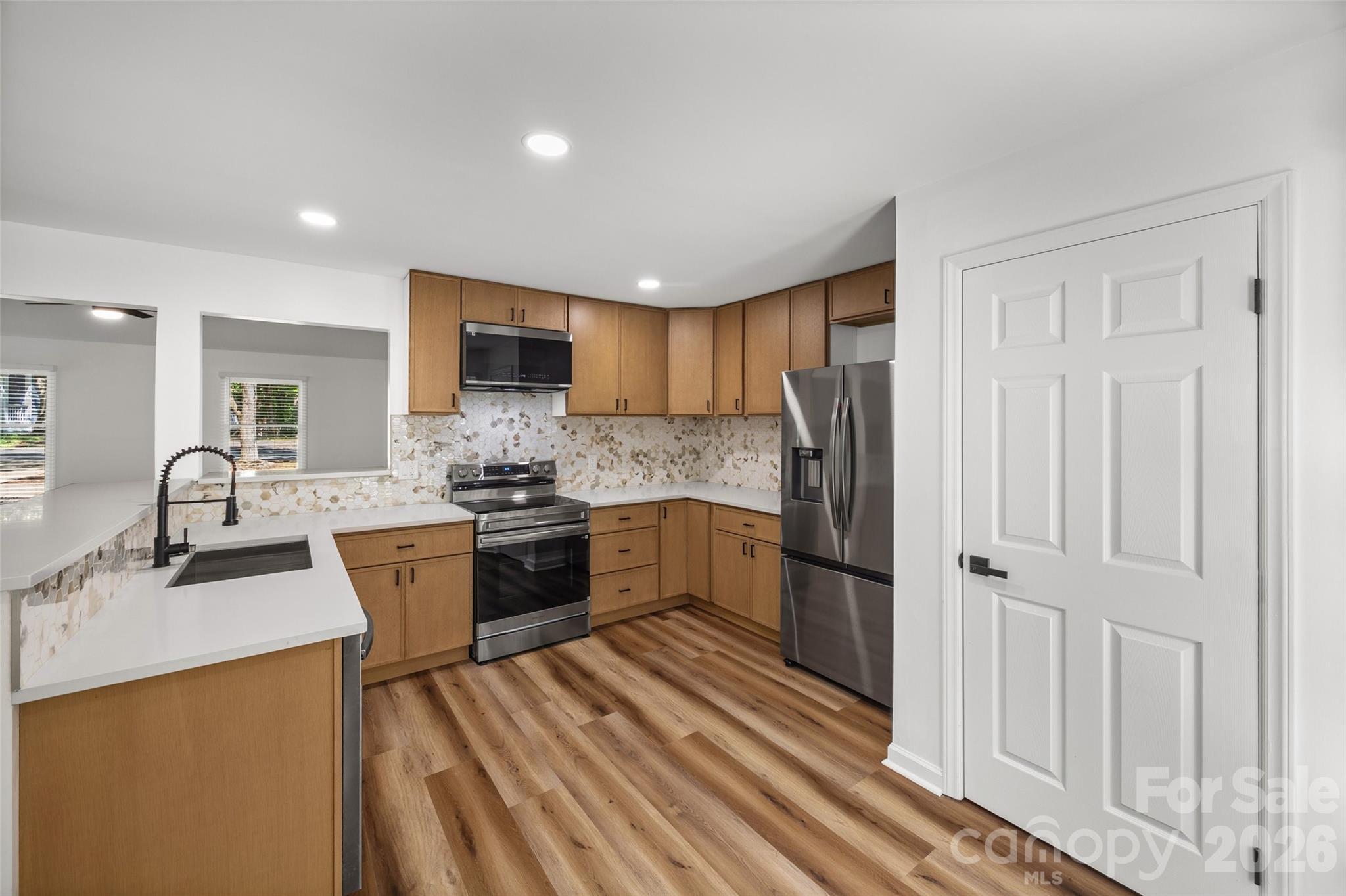 5043 Suwarrow Circle Tega Cay, SC 29708 - Photo 10 of 22 a kitchen with stainless steel appliances granite countertop a refrigerator sink and white cabinets