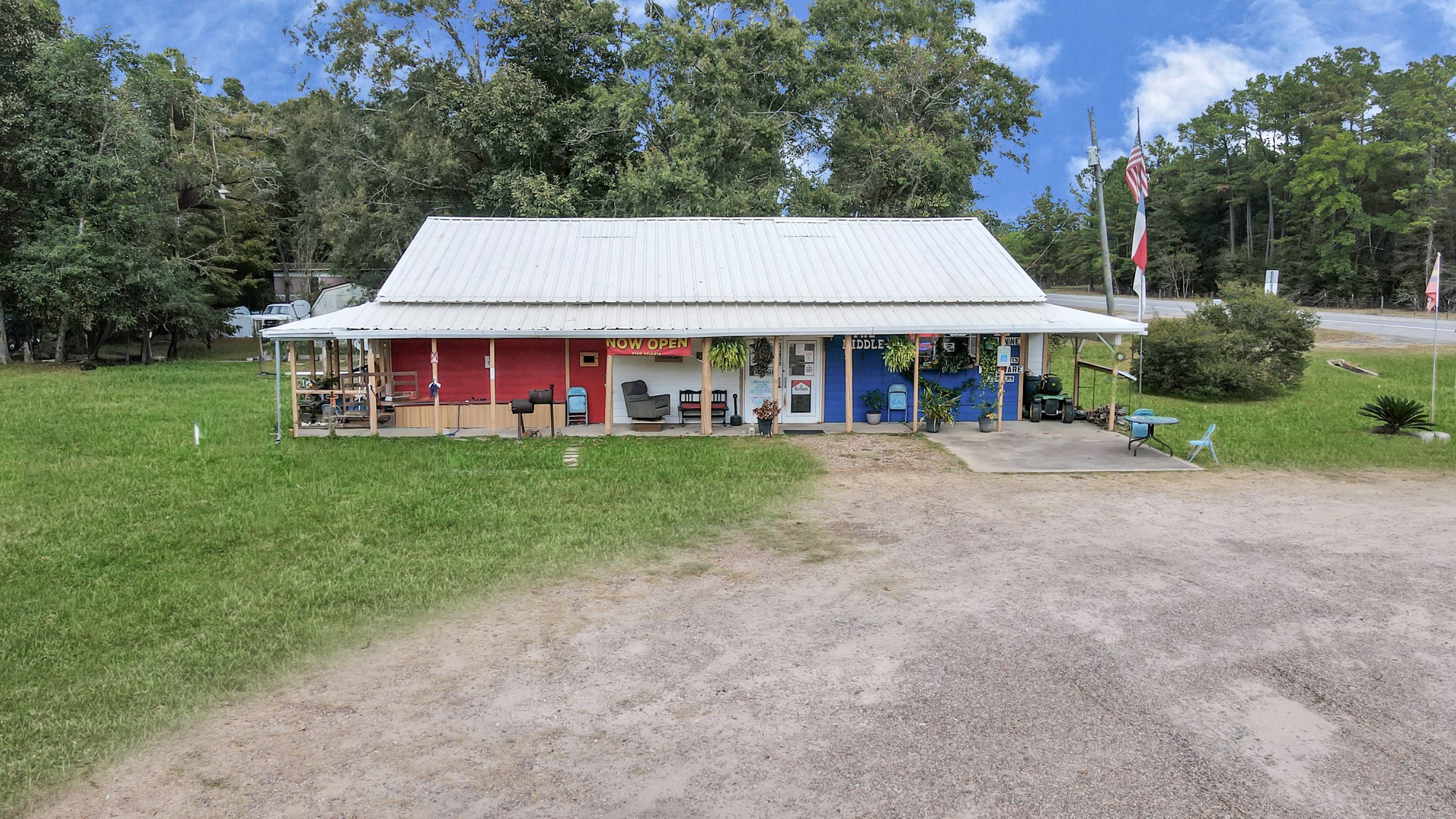 a view of a white house with a big yard and large trees