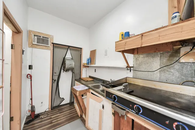 a living room with furniture a ceiling fan and a window