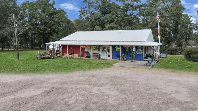 a view of a house with a yard and sitting area