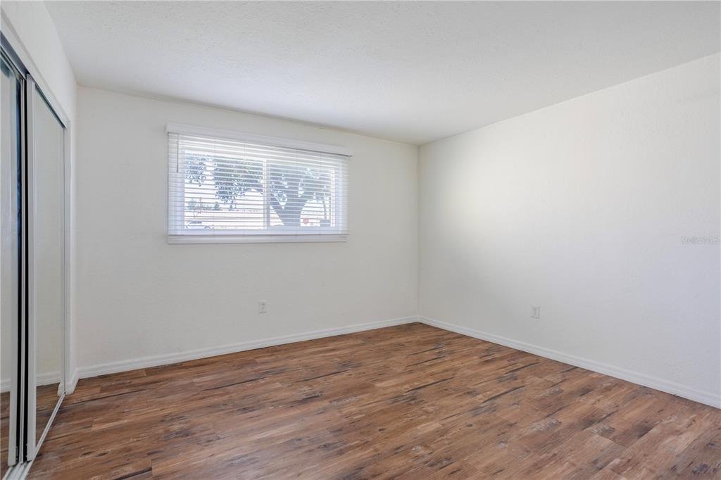 902 Lake Destiny Road, Unit C Altamonte Springs, FL 32714 - Photo 11 of 24 an empty room with wooden floor and windows