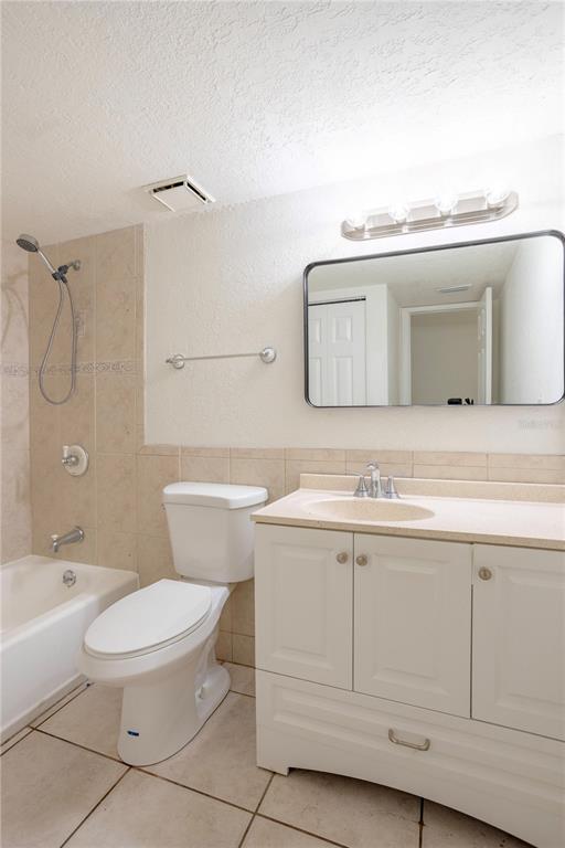 902 Lake Destiny Road, Unit C Altamonte Springs, FL 32714 - Photo 12 of 24 a bathroom with a granite countertop toilet sink and mirror