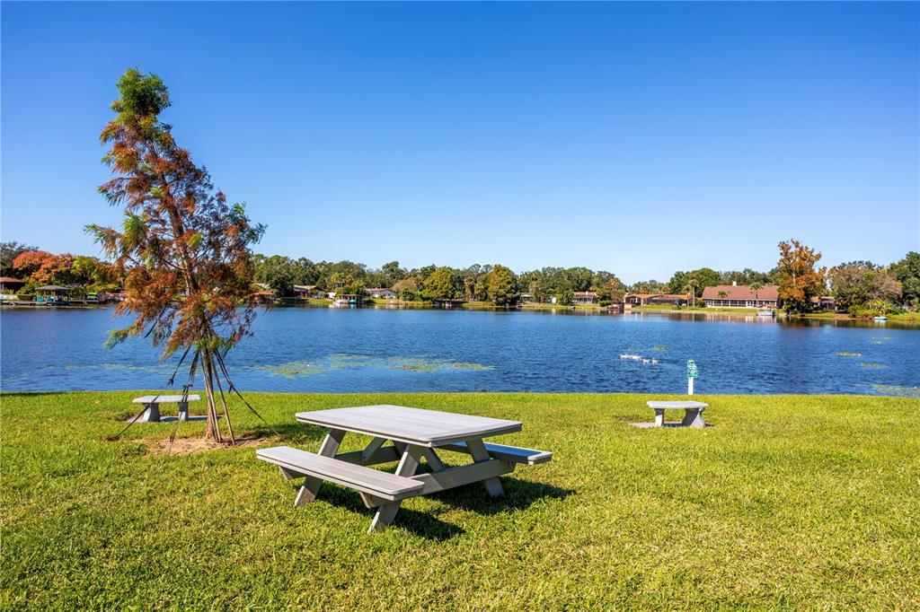 902 Lake Destiny Road, Unit C Altamonte Springs, FL 32714 - Photo 21 of 24 a swimming pool with outdoor seating and yard