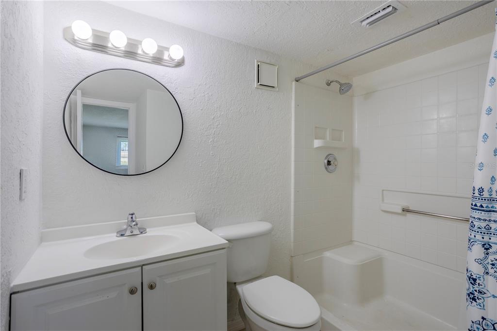 902 Lake Destiny Road, Unit C Altamonte Springs, FL 32714 - Photo 9 of 24 a bathroom with a toilet sink and mirror