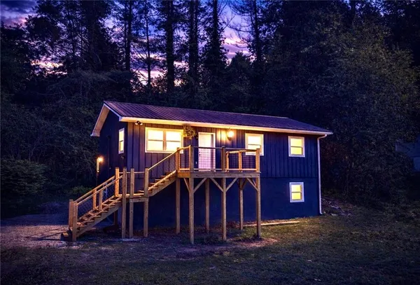 a view of a house with a yard balcony and tree s