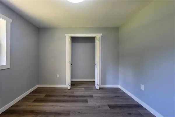 a view of an empty room and wooden floor