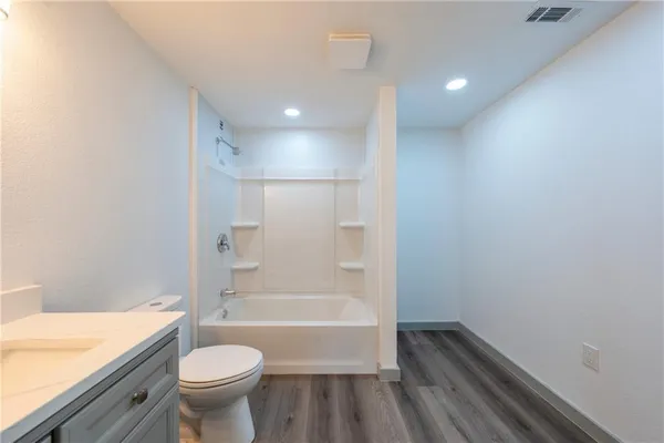 a bathroom with a sink a bathtub and a toilet