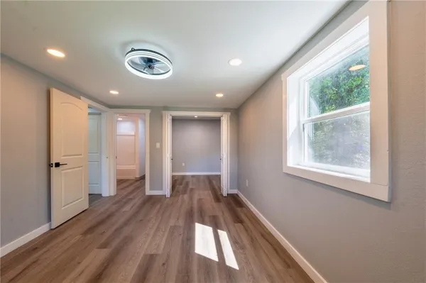 a view of a room with wooden floor and window