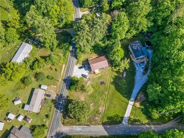 an aerial view of a house with a yard basket ball court and outdoor seating