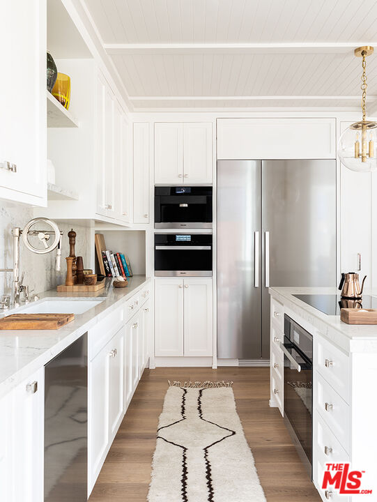 929 Marco Place Venice, CA 90291 - Photo 12 of 38 a kitchen with granite countertop a sink stove and refrigerator