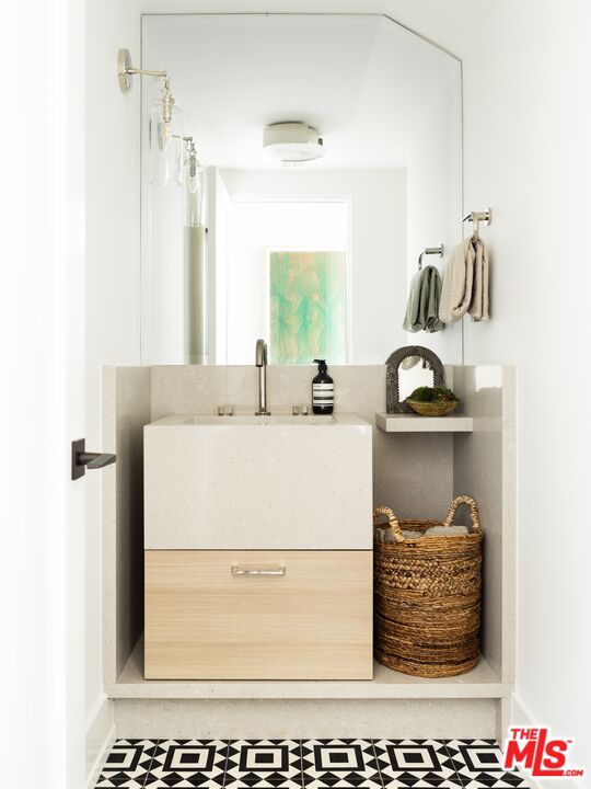929 Marco Place Venice, CA 90291 - Photo 18 of 38 a bathroom with a sink and a mirror